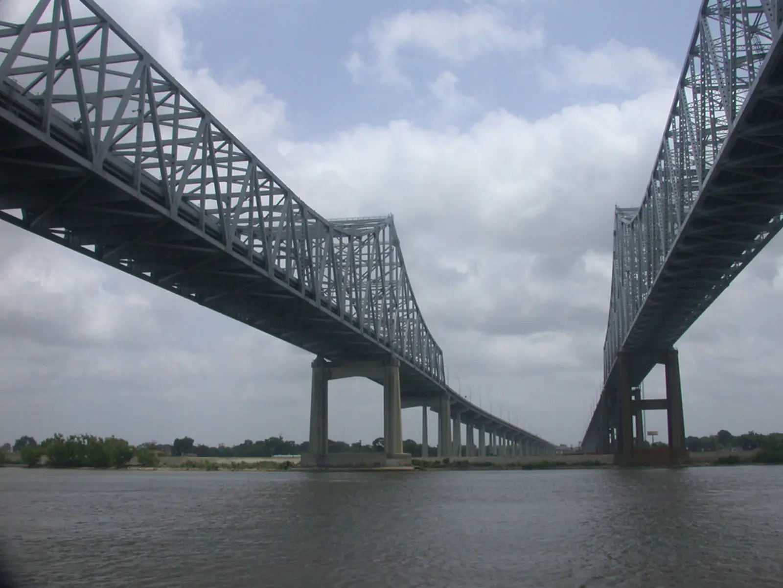 Two large steel truss bridges span a wide river beneath a cloudy sky. The photographer titled it “Lower Mississippi PORTS”.